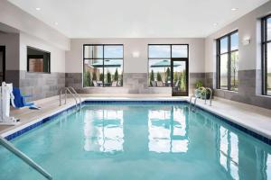 a swimming pool with blue water in a house at Hampton Inn & Suites Bridgeview Chicago, Il in Bridgeview