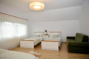 a living room with two beds and a couch at Silent House Sovata in Sovata