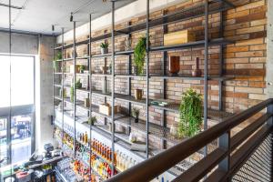 a brick wall with shelves with plants on it at The Londoner Hotel Sliema in Sliema