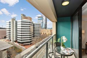 a balcony with a view of a city at Lily - North Terrace Cityscape Residence in Adelaide