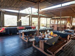 a restaurant with tables and chairs in a room at Buffalo Rock Tented Camp in Hazyview