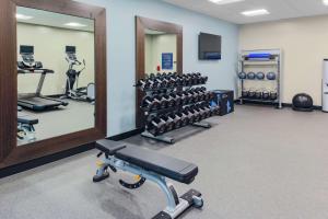 a gym with a rack of dumbbells and a mirror at Hampton Inn Dunedin, Fl in Dunedin