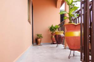 a hallway with potted plants on the stairs at We care 4 you lodge in Kasoa