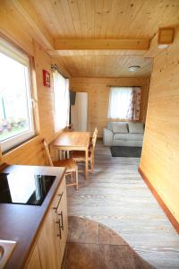 a small living room with a table and a couch at Domki ELDORADO in Dębki