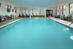 a swimming pool with blue water in a building at Homewood Suites By Hilton Denver Airport Tower Road in Denver