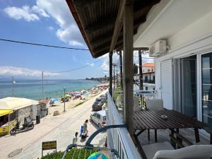 a balcony of a building with a view of a beach at Anemomylos apartment sea view in Pefkohori