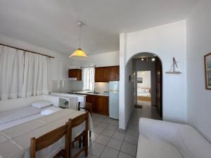 a living room with a bed and a kitchen at Anemomylos apartment sea view in Pefkohori