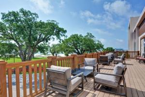 a patio with chairs and tables on a deck at Hilton Garden Inn Biloxi in Biloxi