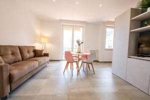 a living room with a couch and a table and chairs at Casa Arbanella in Varazze