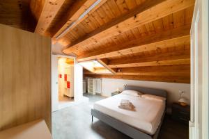 a bedroom with a bed and wooden ceilings at Hbhall Residenze Darsena in Milan