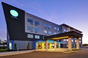 a hotel with a lit up sign on the side of it at Tru By Hilton Huber Heights Dayton in Huber Heights