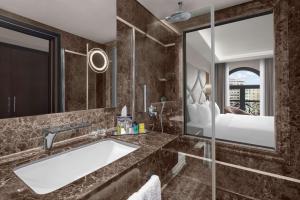 a bathroom with a sink and a large mirror at DoubleTree by Hilton Istanbul Gayrettepe in Istanbul