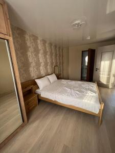 a bedroom with a large bed with white sheets at superior villas in Tbilisi City