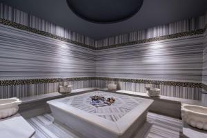 a large room with a tub and two sinks at DoubleTree by Hilton Istanbul Gayrettepe in Istanbul +82 photos