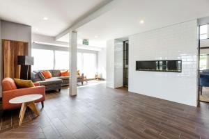 a living room with a couch and a fireplace at Hampton Inn & Suites by Hilton Québec - Beauport in Quebec City