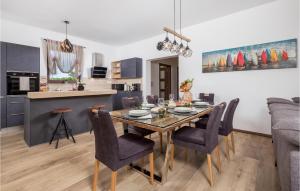 a dining room and kitchen with a table and chairs at Nice Home In Soboli, Cavle With Sauna in Soboli