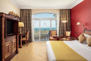 a hotel room with a bed and a view of the ocean at Palm Royale Resort - Soma Bay in Hurghada