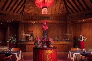 a dining room with two tables and a red centerpiece at Palm Royale Resort - Soma Bay in Hurghada