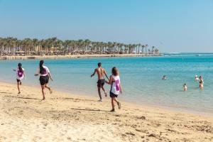 a group of people playing on the beach at Palm Royale Resort - Soma Bay in Hurghada