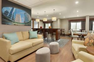 a living room with a couch and a dining room at Hampton Inn Houston Hobby Airport in Houston