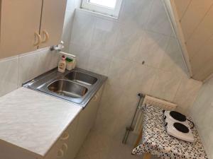 a small kitchen with a sink and a stool at Apartment Siofok, Lake Balaton 1 in Siófok +19 photos