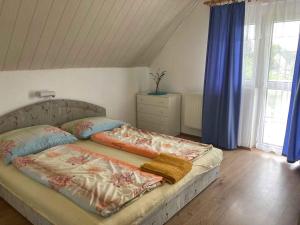 a bedroom with a bed with two pillows on it at Apartment Siofok, Lake Balaton 1 in Siófok