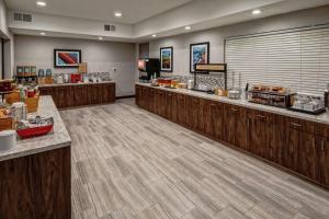 a restaurant with wooden counters and aasteryasteryasteryasteryasteryasteryasteryasteryastery at Hampton by Hilton Encinitas-Cardiff Beach Area in Encinitas
