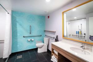 a bathroom with a toilet and a sink at Tru By Hilton Greenville in Greenville +28 photos