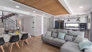 a living room with a couch and a table at Ramales Alhaurín de la Torre by Ruralidays in Alhaurín de la Torre