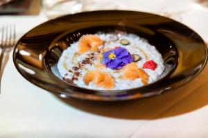 a bowl of rice with a flower on top of it at Hotel Ramon in Campitello di Fassa