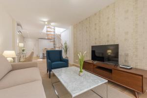 sala de estar con sofá y TV en The Terraces Luxury Penthouses, 3B, en Santa Cruz de Tenerife