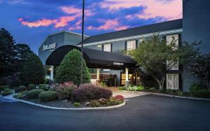 a hotel front of a building with flowers and plants at The Burgundy Hotel, Tapestry Collection by Hilton in Little Rock