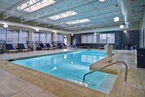 a large pool with a hot tub in a building at DoubleTree by Hilton Oceanfront Virginia Beach in Virginia Beach