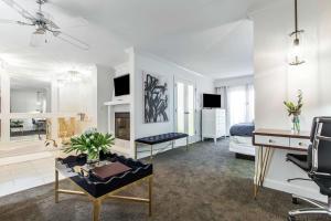 a living room with a bed and a desk at The Burgundy Hotel, Tapestry Collection by Hilton in Little Rock