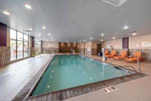 a large pool in a hotel lobby with at Home2 Suites By Hilton Portland Hillsboro in Hillsboro