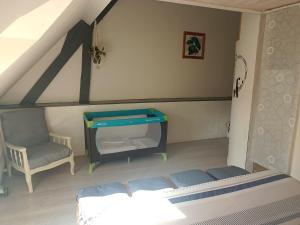 a bedroom with a bed and a tv in a room at Le Fouzon in Meusnes