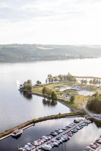 an aerial view of a marina with cars parked at Wood Hotel by Frich's in Brumunddalen
