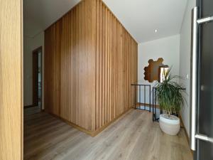 a hallway with a wooden wall and a potted plant at Casa da Milinha - Villa with a Pool near Rio Douro in Santa Cruz do Douro