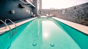 a swimming pool with blue water in a building at Hampton Inn Riverside Downtown in Riverside