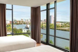a bedroom with a view of a river at Homewood Suites By Hilton Wilmington Downtown in Wilmington