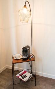 a table with a telephone and a lamp on it at Wok Rooms in Brussels