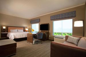 a hotel room with a bed and a desk and a tv at Hampton Inn & Suites Kutztown, Pa in Kutztown