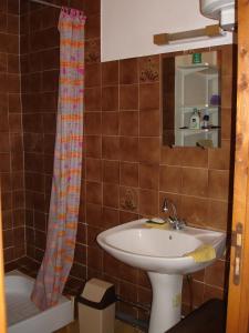 a bathroom with a sink and a shower curtain at Maison Vacances Mer in Bages