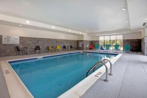 a large swimming pool in a hotel room at Home2 Suites By Hilton Charlotte Northlake in Charlotte