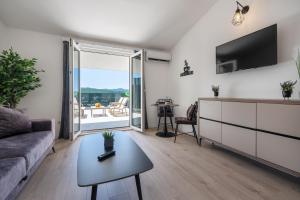 a living room with a couch and a table at Villa Golden in Neum