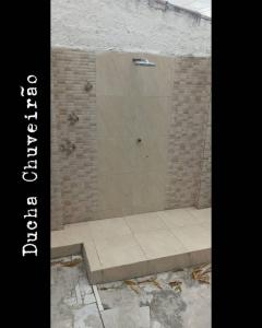 a shower stall with a bench next to a brick wall at Veraneio Dona Rosa in Piranhas