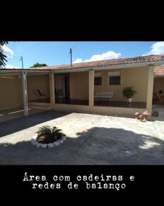 a large house with a patio in front of it at Veraneio Dona Rosa in Piranhas