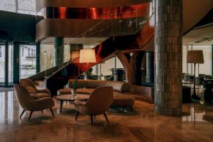 a lobby with a couch and chairs and a table at Hilton Swinoujscie Resort And Spa in Świnoujście