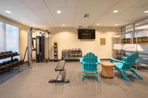 a gym with blue chairs and a treadmill at Home2 Suites By Hilton Omaha Un Medical Ctr Area in Omaha