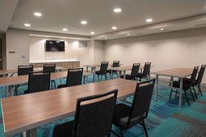 a conference room with wooden tables and chairs at Home2 Suites By Hilton Omaha Un Medical Ctr Area in Omaha